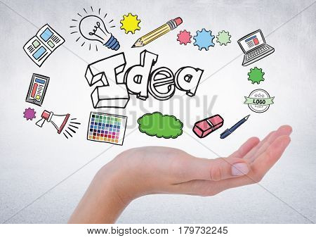 Digital composite of Hand with idea doodles against white wall