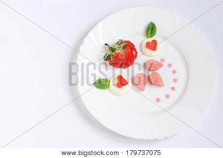 Delicate dessert for ladies with fresh strawberries biscuit cake cream and jelly. Gourmet food. Served on Valentine's Day Women's Day Mother's Day