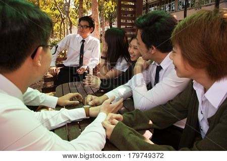 Bangkok, Thailand - November 17, 2015 : 
King Mongkut's Institute of Technology Ladkrabang is a research and educational institution in Thailand.
A group of student have fun talking and playing in the garden.