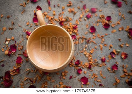 Wooden cup for hot drink cup make from wooden on dry rose petals