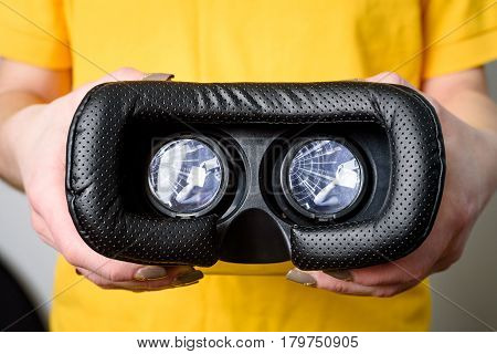 Virtual Reality Concept. Man Or Women Holding In Hand Vr Glasses Device With Futuristic Image In Len