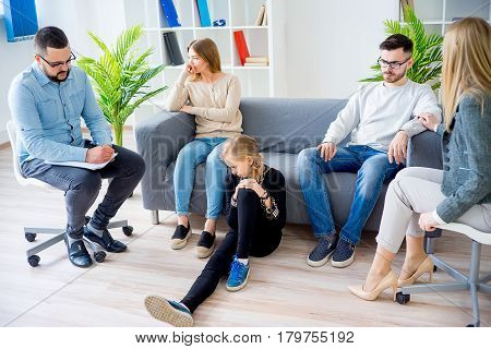 A rebellious teen daughter in family therapy