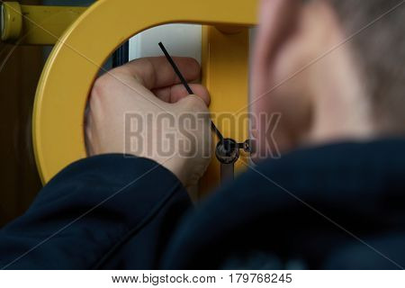 Intruder or Burglar with lockpick tool opens the front door to enter the house. could also be used for key service or locksmith concept