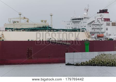 GAS TANKER AT THE NAVIGATION SIGN - Tanker sails out to the sea