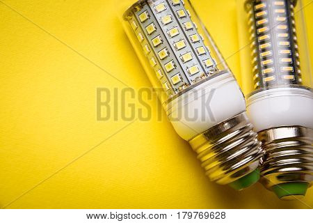 Energy Saving Led Light Bulb On A Yellow Background With Empty Space
