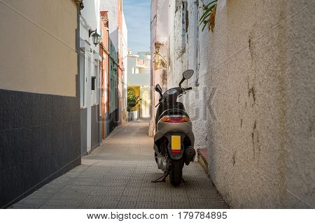 Scooter parked at narrow street of Icod de los Vinos old town. Tenerife, Canary islands, Spain.