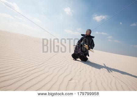 Man In Traditional Armor Ready To Practice Martial Art In A Wilderness