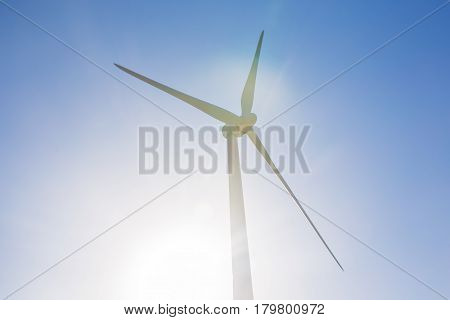 Green renewable energy concept - wind generator turbines in sky.