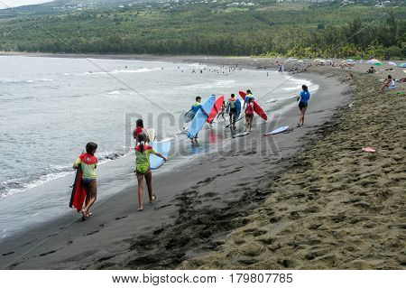 People Walking On The Beach To Join The Surfing Lesson