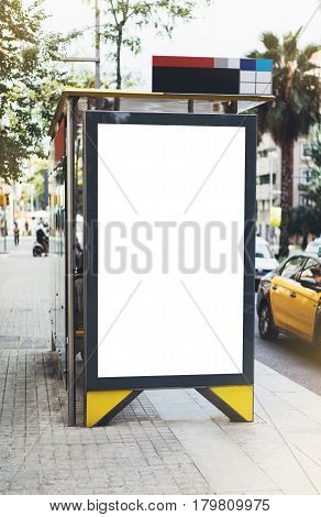 Blank advertising light box on bus stop mockup of empty ad billboard on night bus station template banner on background city street for message or text in Barcelona afisha board and headlights of taxi cars