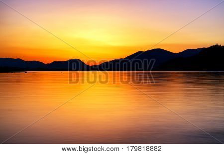 Beautiful sunrise on lake Liptovska Mara Slovakia. Long exposure shot with ND filter