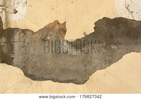 Abstract texture of wall covered with obsolete damaged beige cement plaster