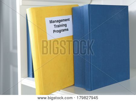 Book of MANAGEMENT TRAINING PROGRAMS on shelf