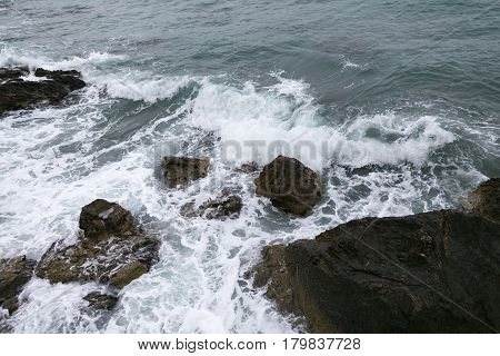 Rocks And Sea Shot On Cloudy Day