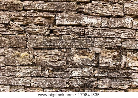 Old masonry made of limestone. Limestone is stratified as a result of atmospheric influences and age.