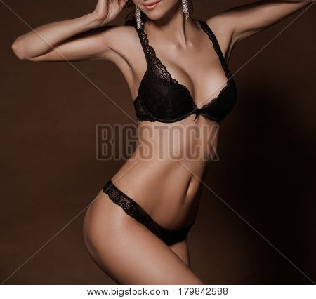 Perfect sporty sexy woman body on brown background