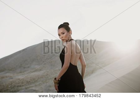 Woman in a black dress in desert