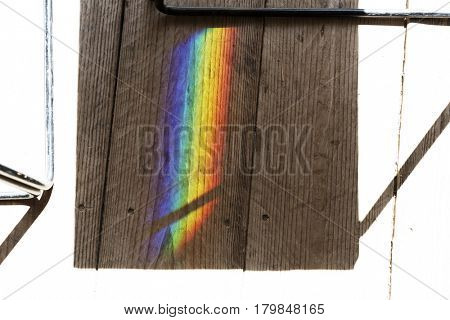 Rainbow reflect on the shadow of the chair