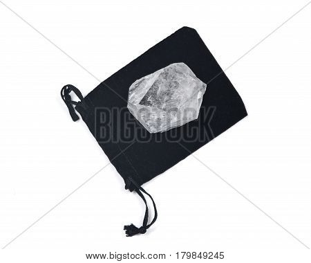 Clear quartz cathedral point on black velveteen crystal pouch isolated on white background