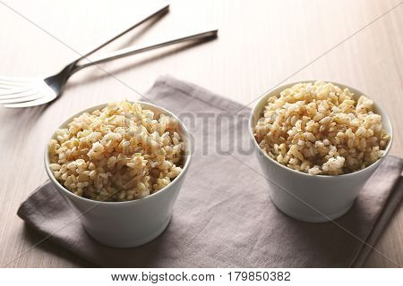 Two bowls of brown rice on napkin