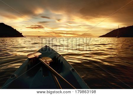 Kayak bow at beautiful sunset background. Kayaking or kanoeing concept