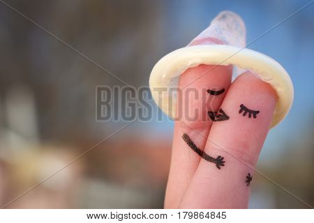 Finger art of a Happy couple. The happy couple kissing and hugging. The concept of safe sex.