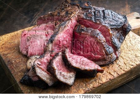 Barbecue dry aged Wagyu Bistecca alla Fiorentina as close-up on an old cutting board 
