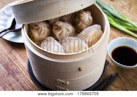 Traditional Chinese Dim Sum as close-up on Bamboo Steamer 