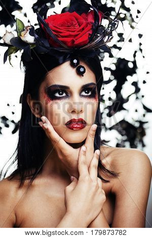 pretty brunette woman with rose jewelry, black and red, bright make up kike a vampire closeup red lips, halloween concept