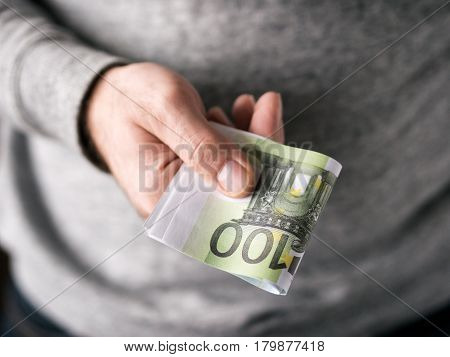 Men's hands hold Euro. Close up. Selective focus