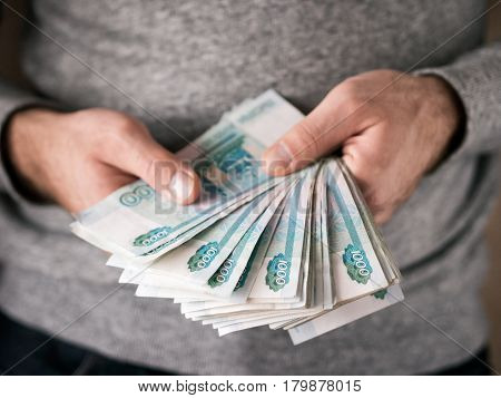 Hands counting russian rubles. Selective focus. Shallow DOF