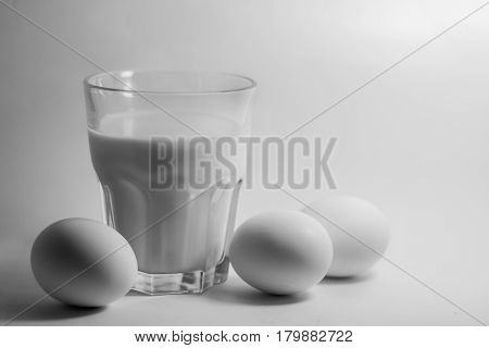 A glass of milk on a white background eggs
