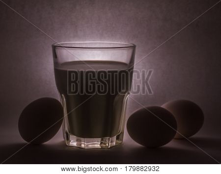 A glass of milk on a white background eggs