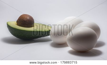 avocado baked with egg on a white background. tinting. selective focus