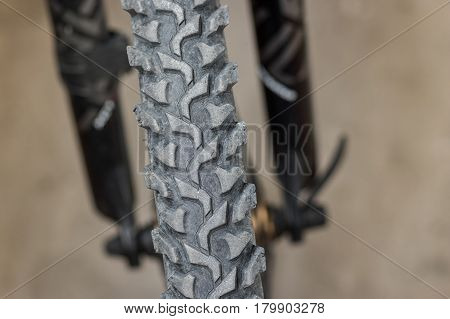 Picture of front bicycle wheel closeup with worn tire (shallow dof)