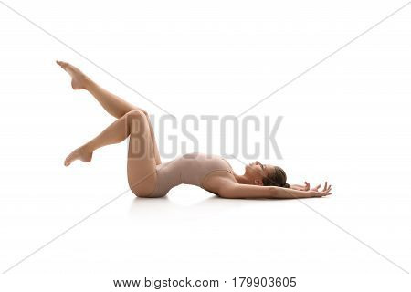 Young female gymnast in sports beige body doing acrobatics together in studio