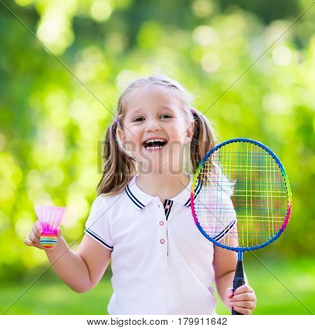 Child Playing Badminton Or Tennis Outdoor In Summer