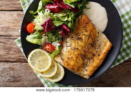 Fried Fillet Of Fish Arctic Char With Fresh Salad And Sauce Close-up. Horizontal Top View