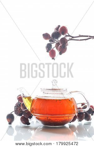 Dried red rose hips and tea on a white background