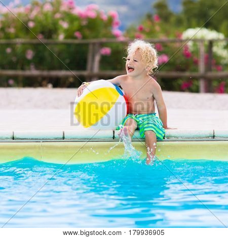 Child In Swimming Pool On Summer Vacation