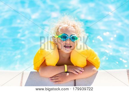 Little Baby Boy Playing In Swimming Pool