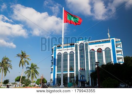 Male, Maldives - December 17, 2016: Shaheedh Hussain Adam Building And National Flag Of Maldives In