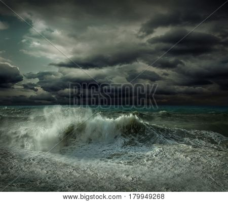 View of great storm on the sea. Strong wind and big waves with splash drops under dark sky.