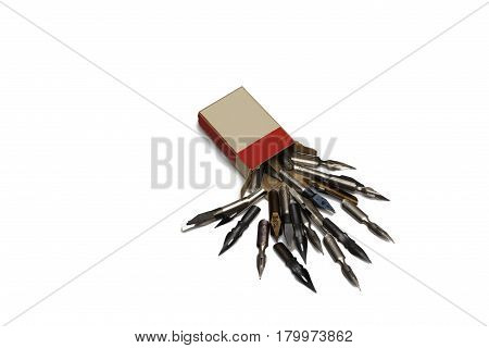 Scattered fountain pen nibs with box isolated on white