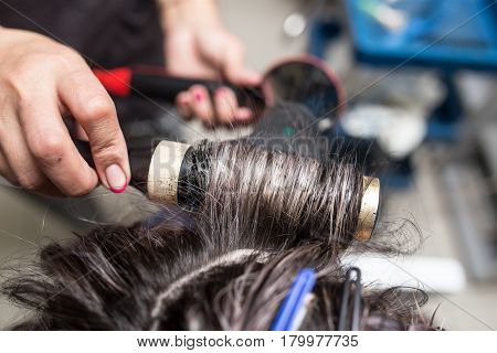 Styling female hair dryer in the beauty salon
