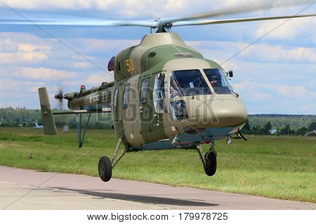 KUBINKA, MOSCOW REGION, RUSSIA - JUNE 18, 2015: Kazan Ansat-U helicopter takes off at Kubinka air force base during Army-2015 forum.