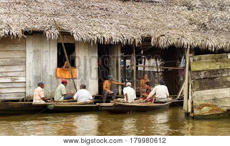 IQUITOS PERU - MARCH 17: Group of men on canoes in the Belen neighborhood in Iquitos Peru