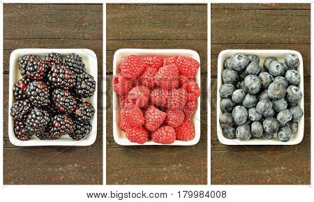 Mix of strawberries, blueberries, blackberries and raspberries fruit on wood table. Forest fruit in white idaeus. Delicious fresh berries.