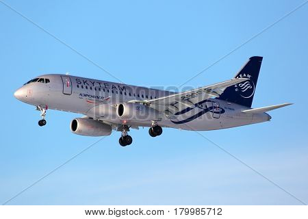 SHEREMETYEVO, MOSCOW REGION, RUSSIA - MARCH 3, 2012: Aeroflot Sukhoi SuperJet100 in SkyTeam alliance livery landing at Sheremetyevo international airport, Moscow region, Russia.