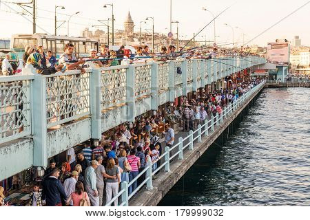 ISTANBUL - MAY 26, 2013: Fishermen and tourists are on the Galata Bridge in Istanbul, Turkey. The Galata Bridge is one of the main attractions of Istanbul.